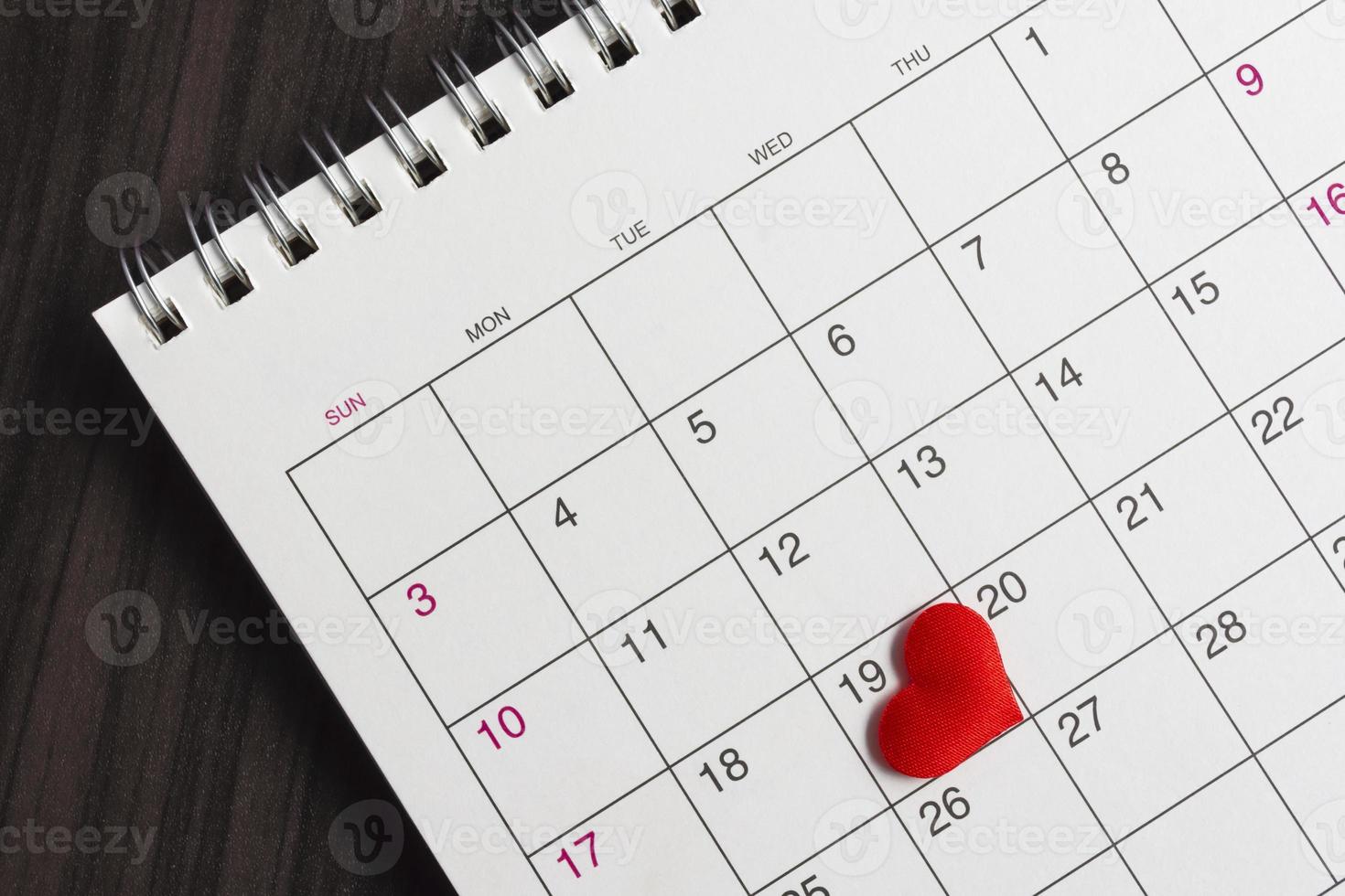Red heart shape on the date of the 19th day in the calendar. photo