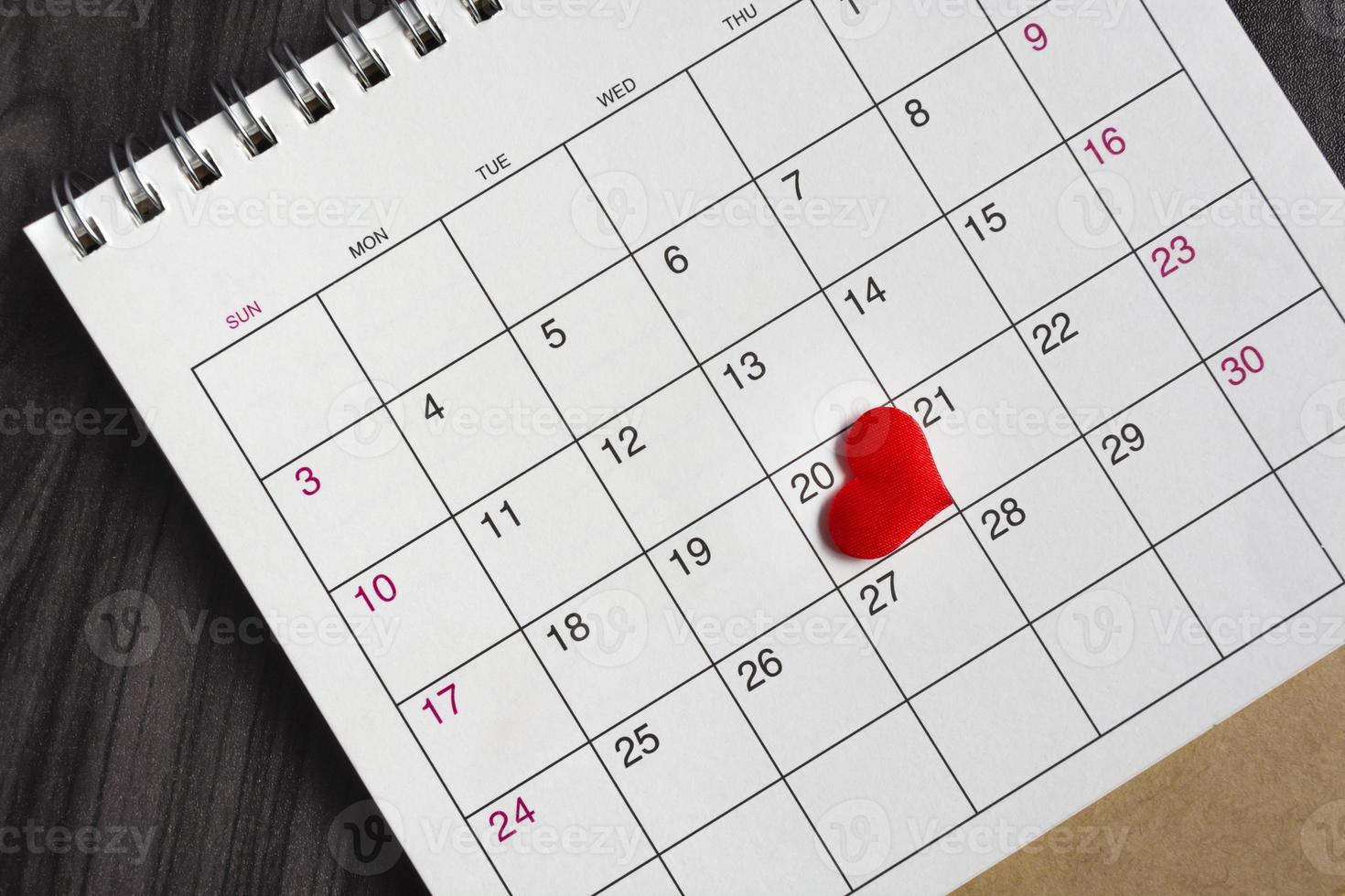 Red heart shape on the date of the 20th day in the calendar. photo