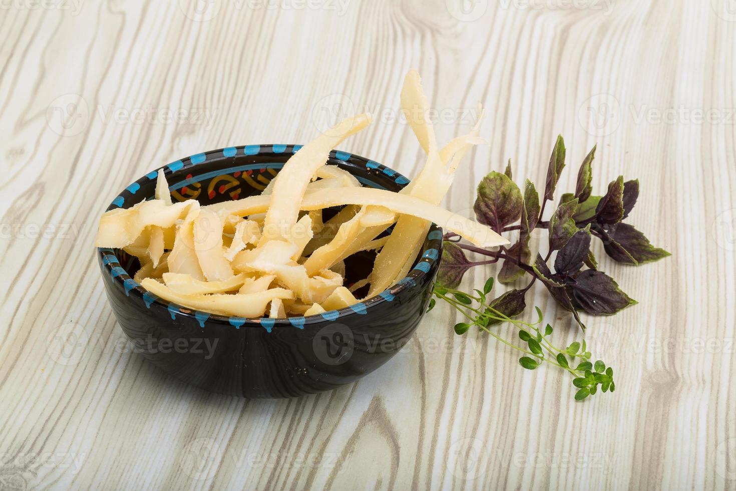 Dried squids in a bowl on wooden background photo