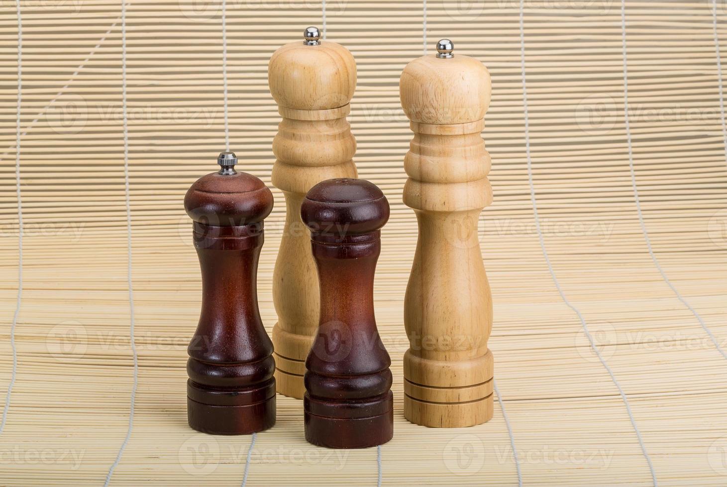 Pepper mill on wooden background photo