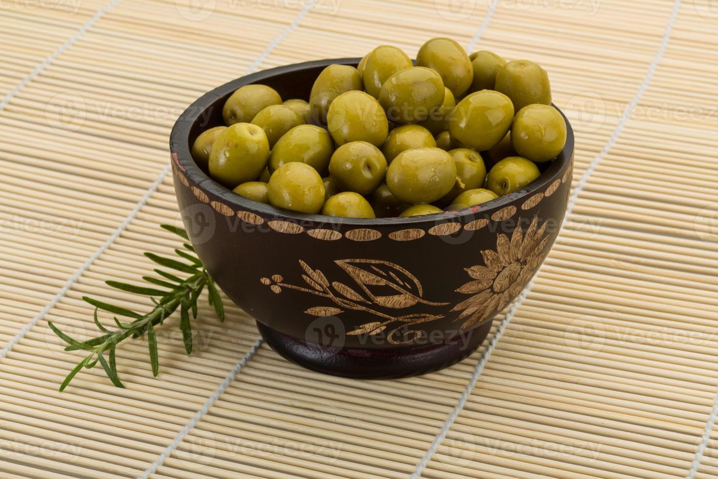 Green olives in a bowl on wooden background 11727395 Stock Photo at