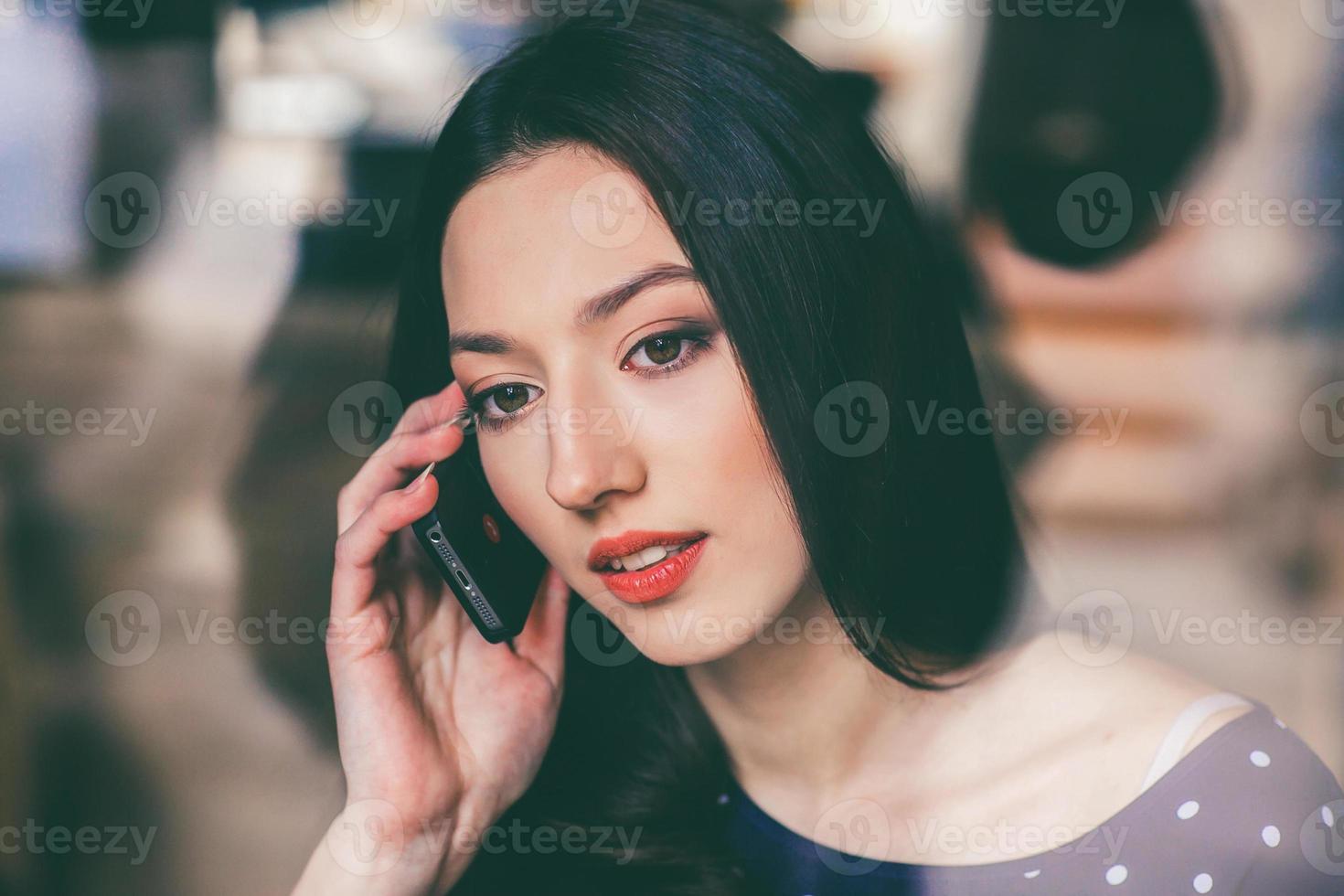 Beautiful girl talking on the phone and smiling photo