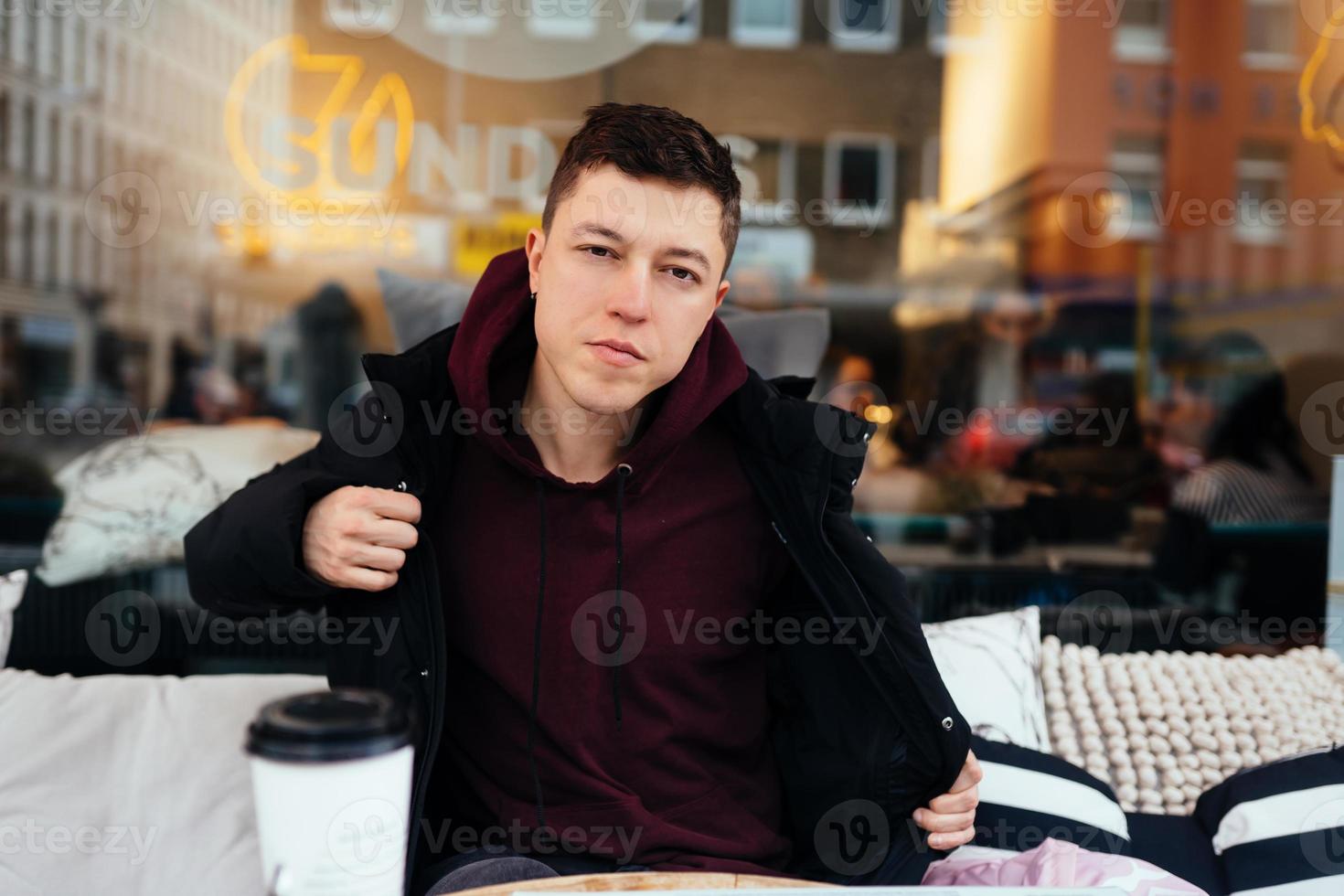 Handsome guy hanging out in an outdoor cafe photo