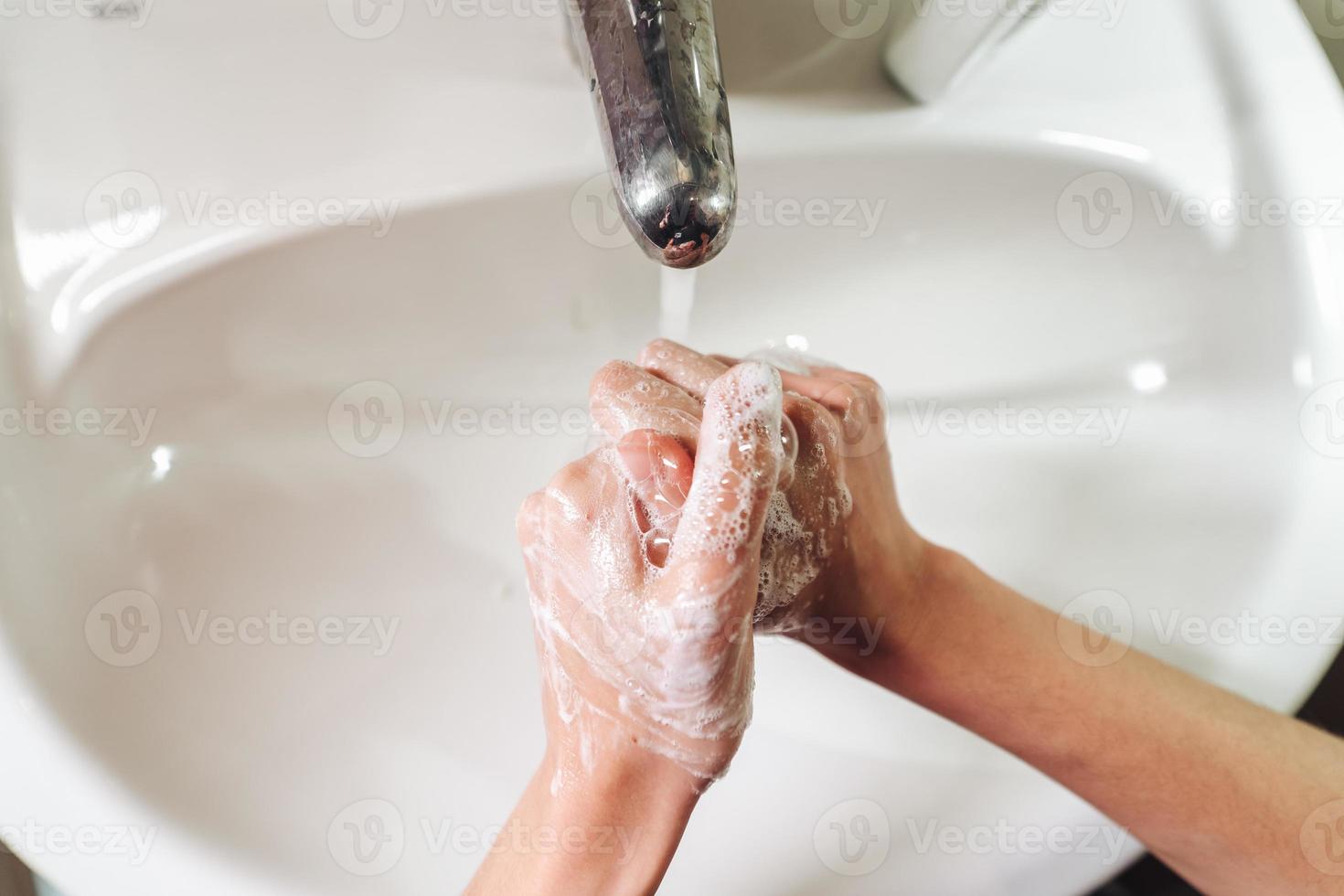 Man washing hands to protect against the coronavirus photo