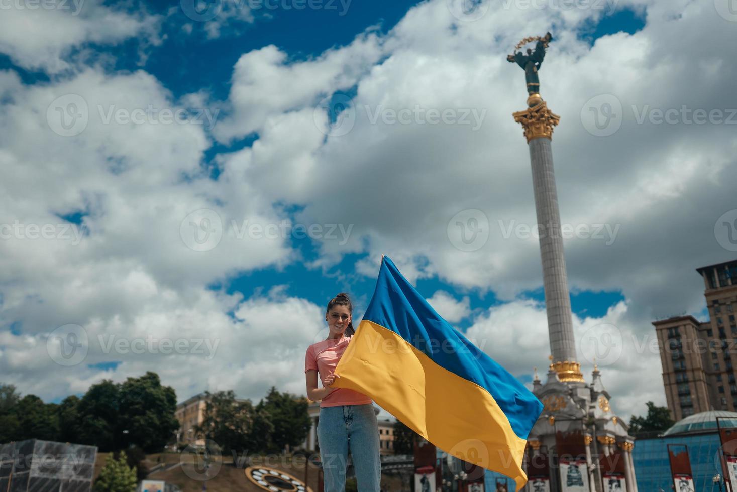 Young woman with national flag of Ukraine on the street photo