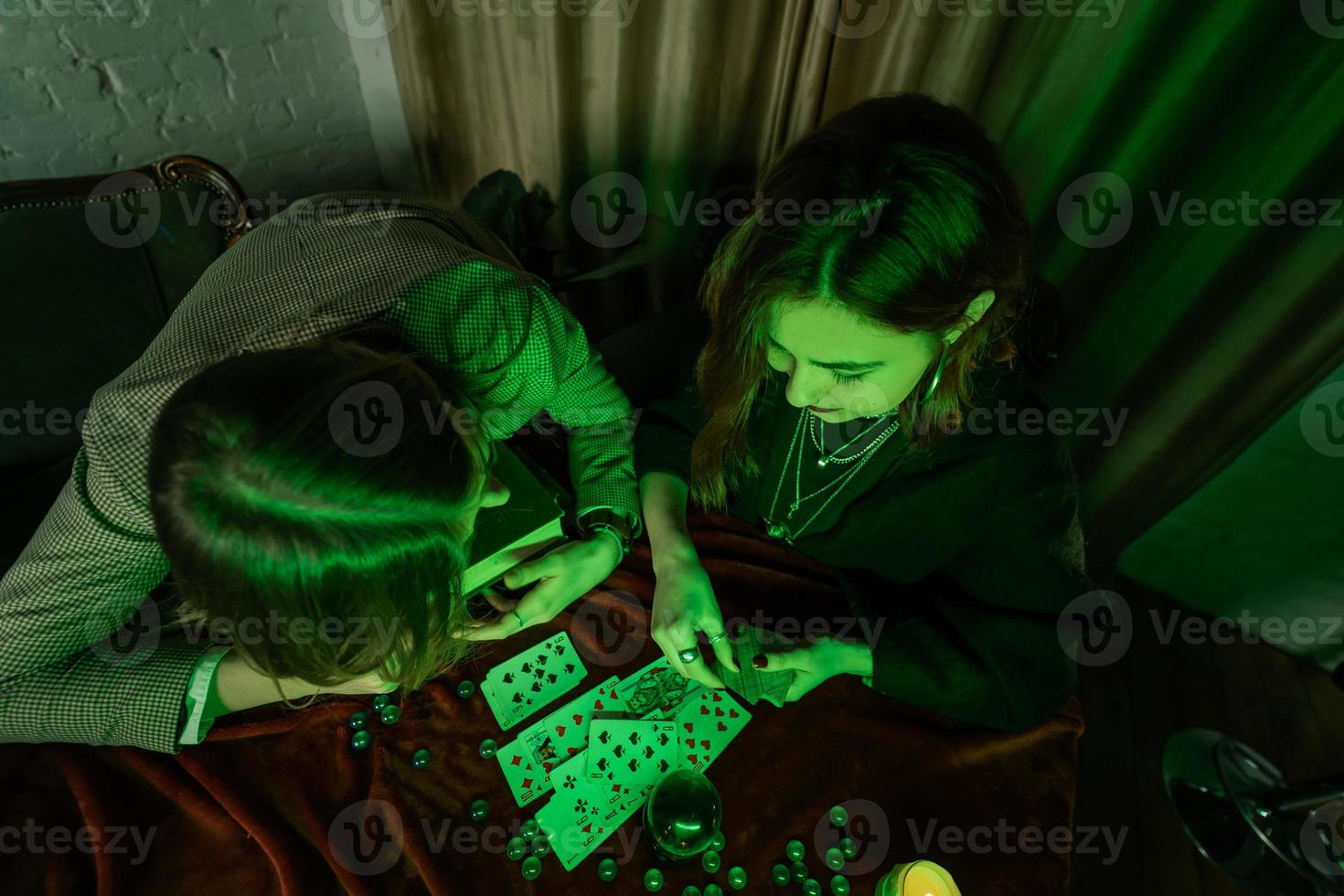 Fortune teller forecasting the future to woman with cards photo