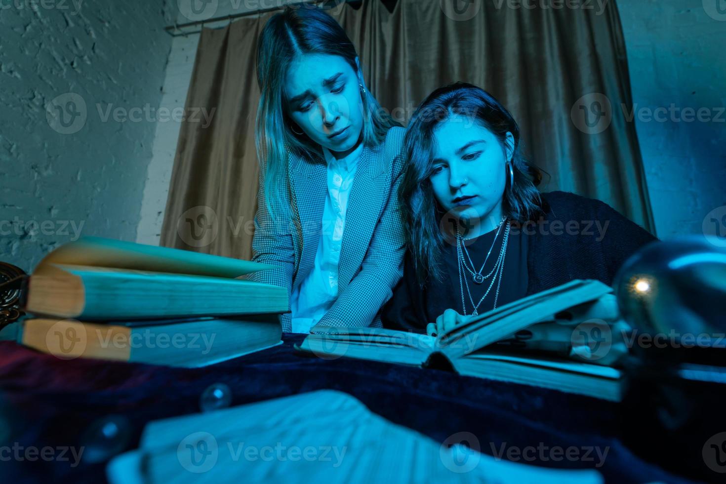 Two women are reading a mysterious book photo