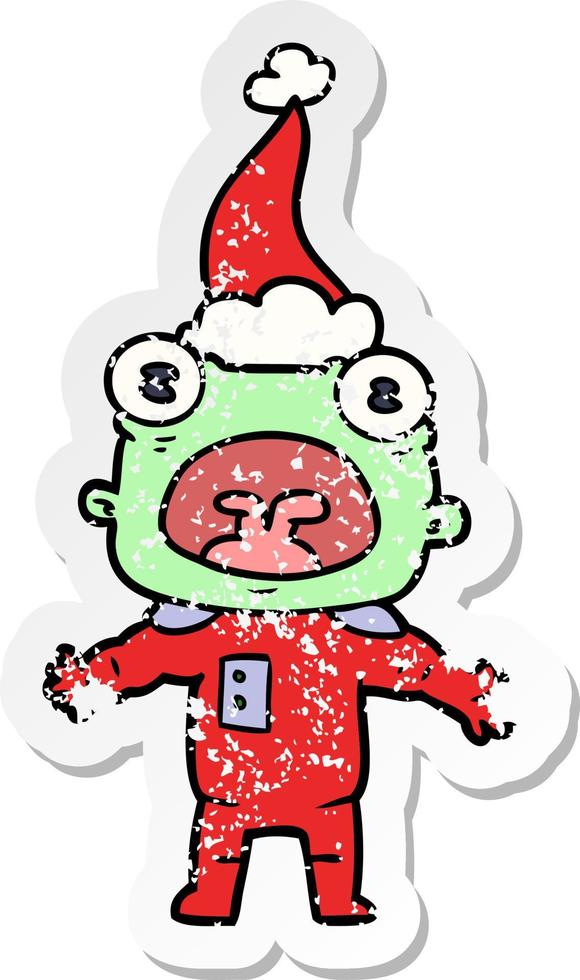 distressed sticker cartoon of a weird alien communicating wearing santa hat vector