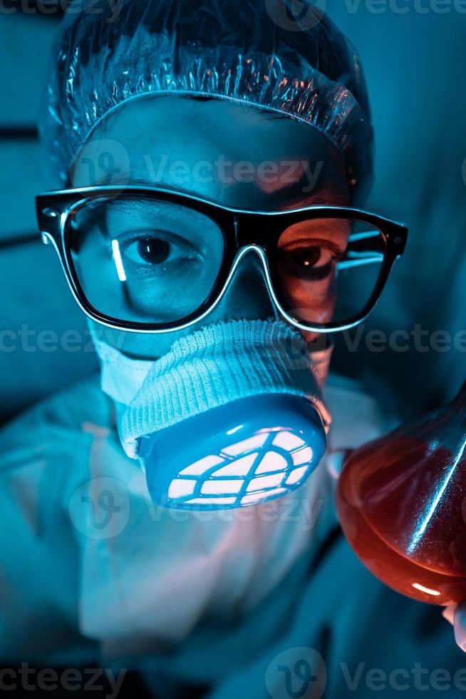 Young male researcher carrying out scientific experiment. photo