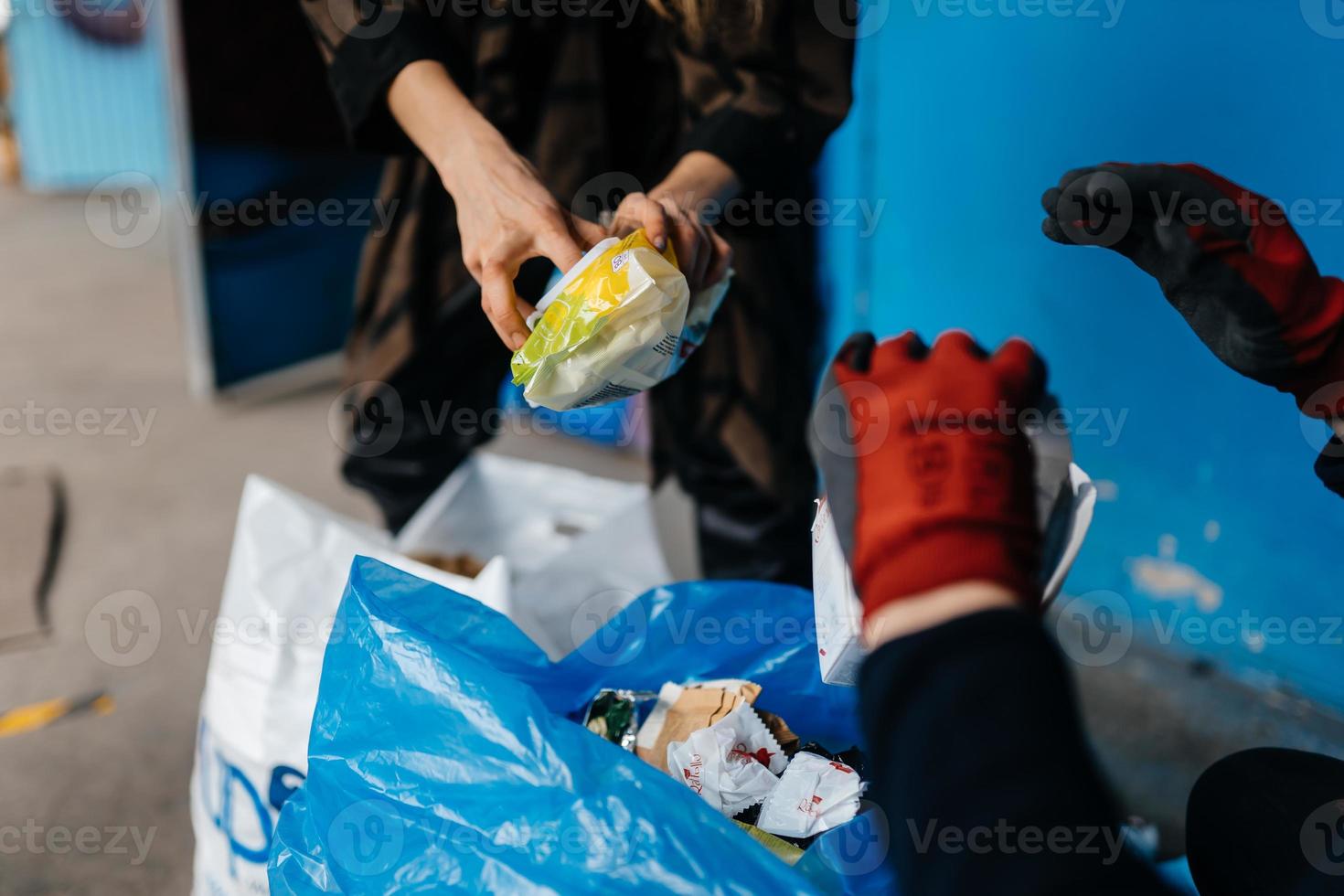 Two perrson sorting garbage. Concept of recycling. Zero waste photo