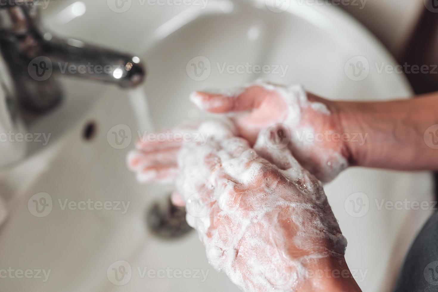 Man washing hands to protect against the coronavirus photo