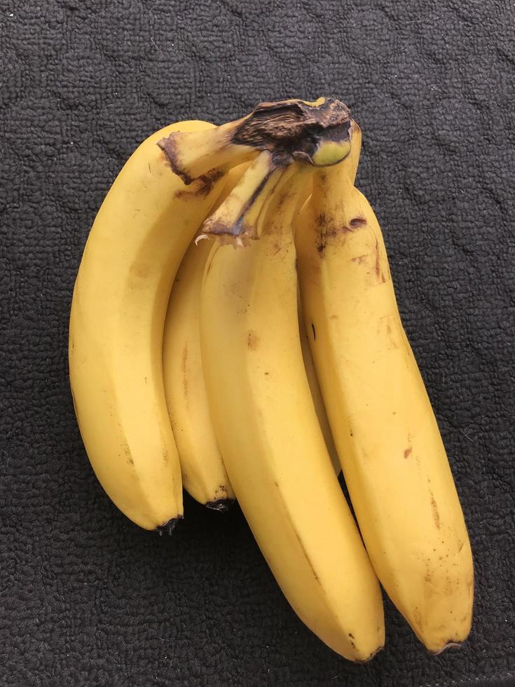a bunch of bananas on a dark background photo