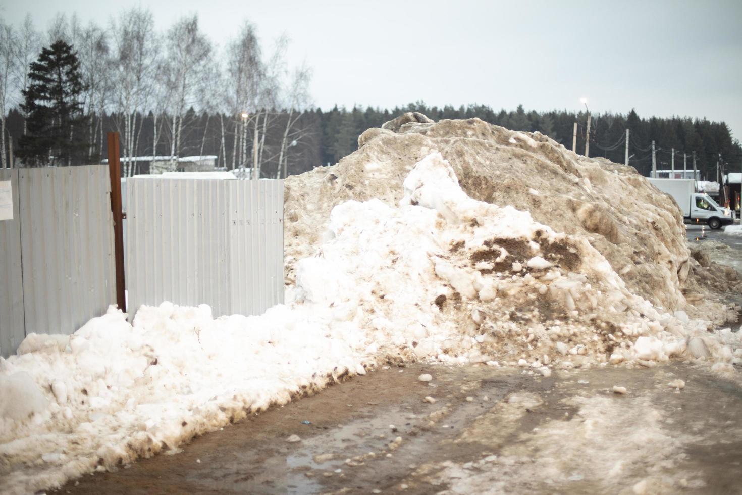 Fence is covered with snow. Removed snow to side of road. photo