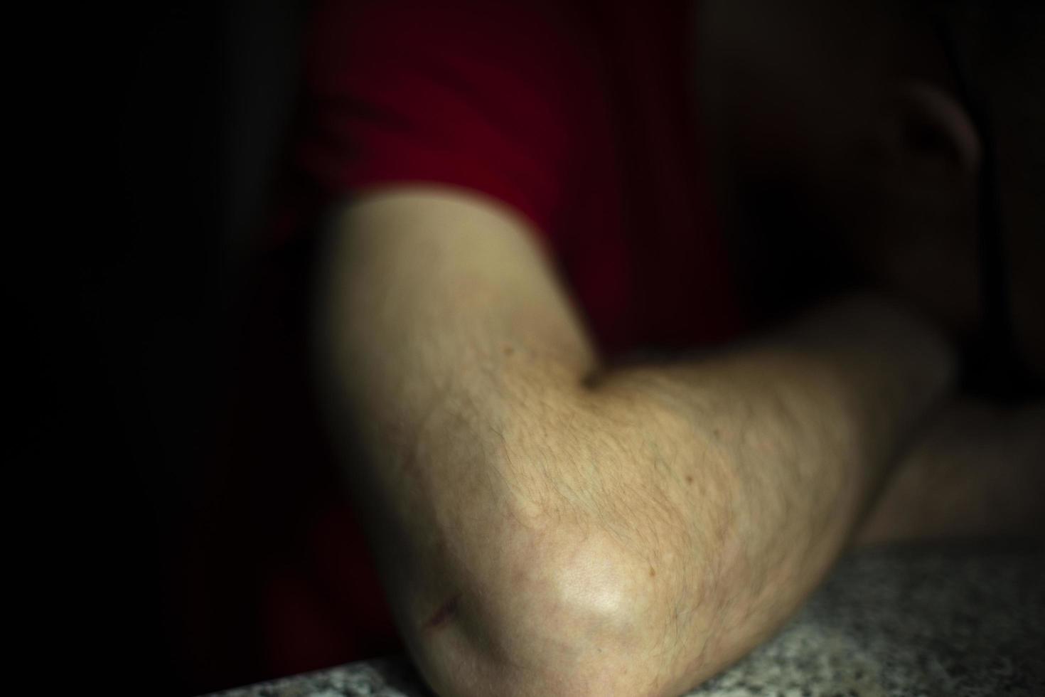 Hand of guy sleeping on table. Man was tired. Depressive state. photo