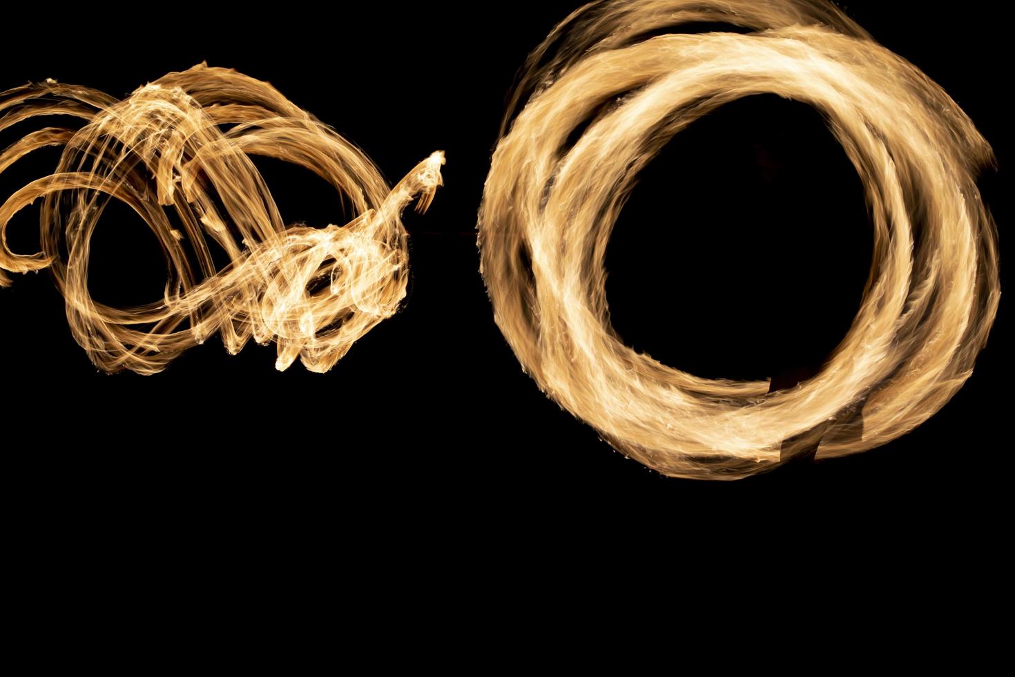 Circles of flames in dark. Fire show on long camera shutter speed. Flames. photo