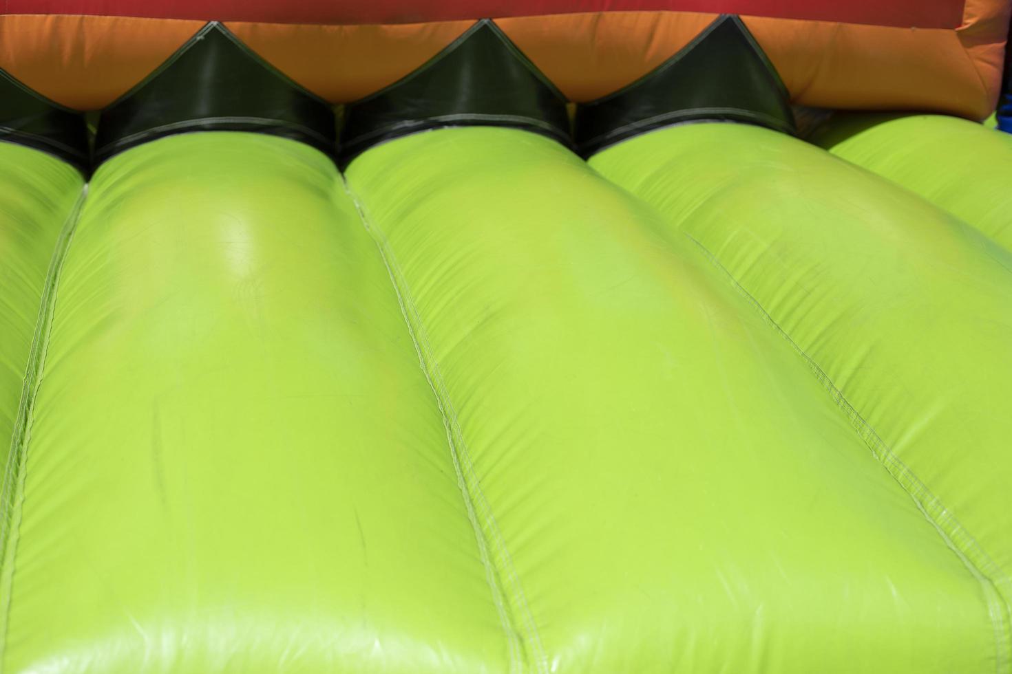 Inflatable trampoline. Amusement park. Green rubber. photo