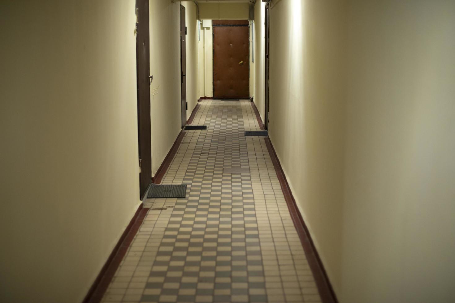 Corridor in house. Tiles in house. Doors in hallway. Entrances were flown. photo