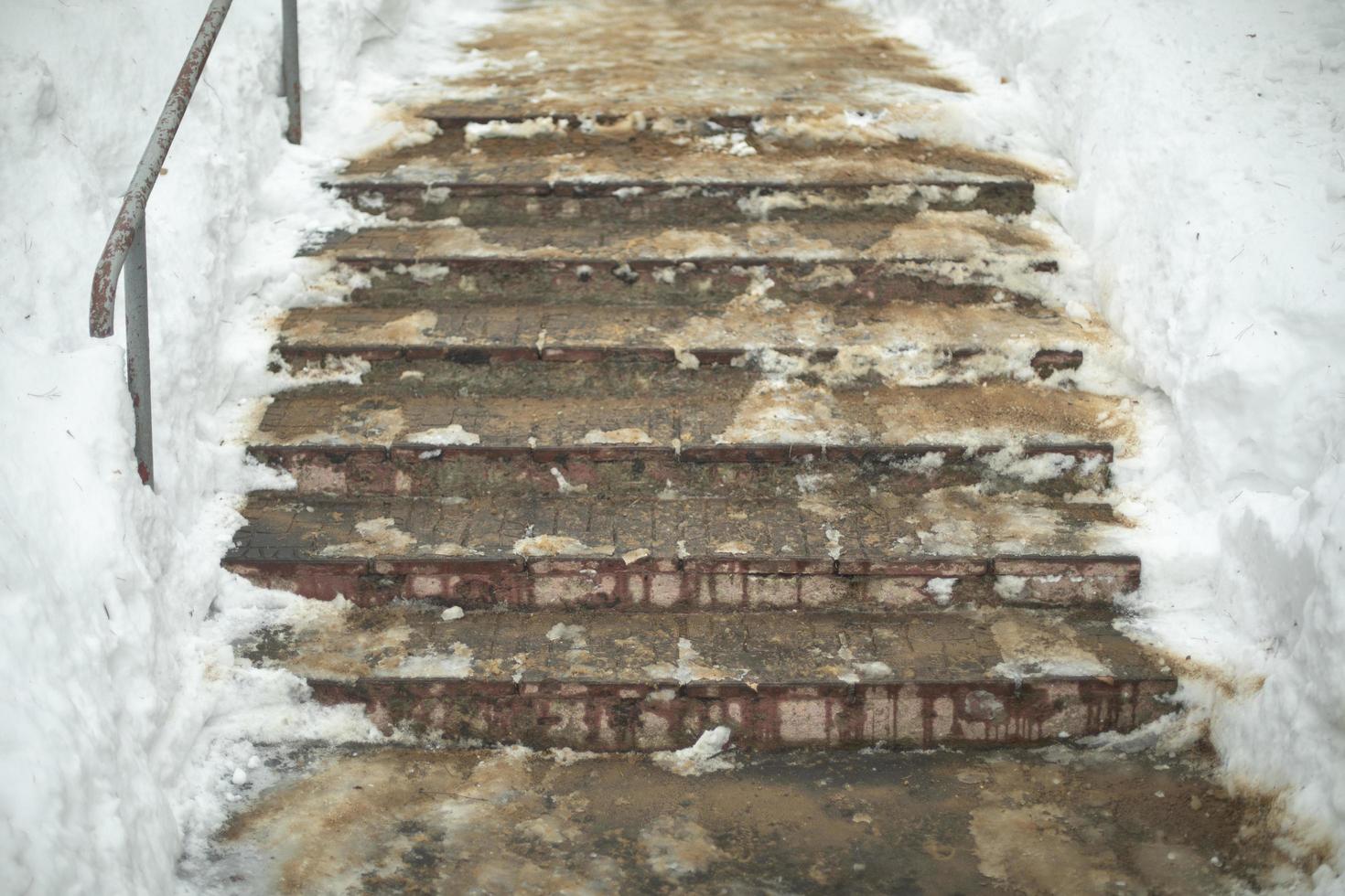 Dirty steps. Stairs outside. Steps in winter. Climbing hill. photo