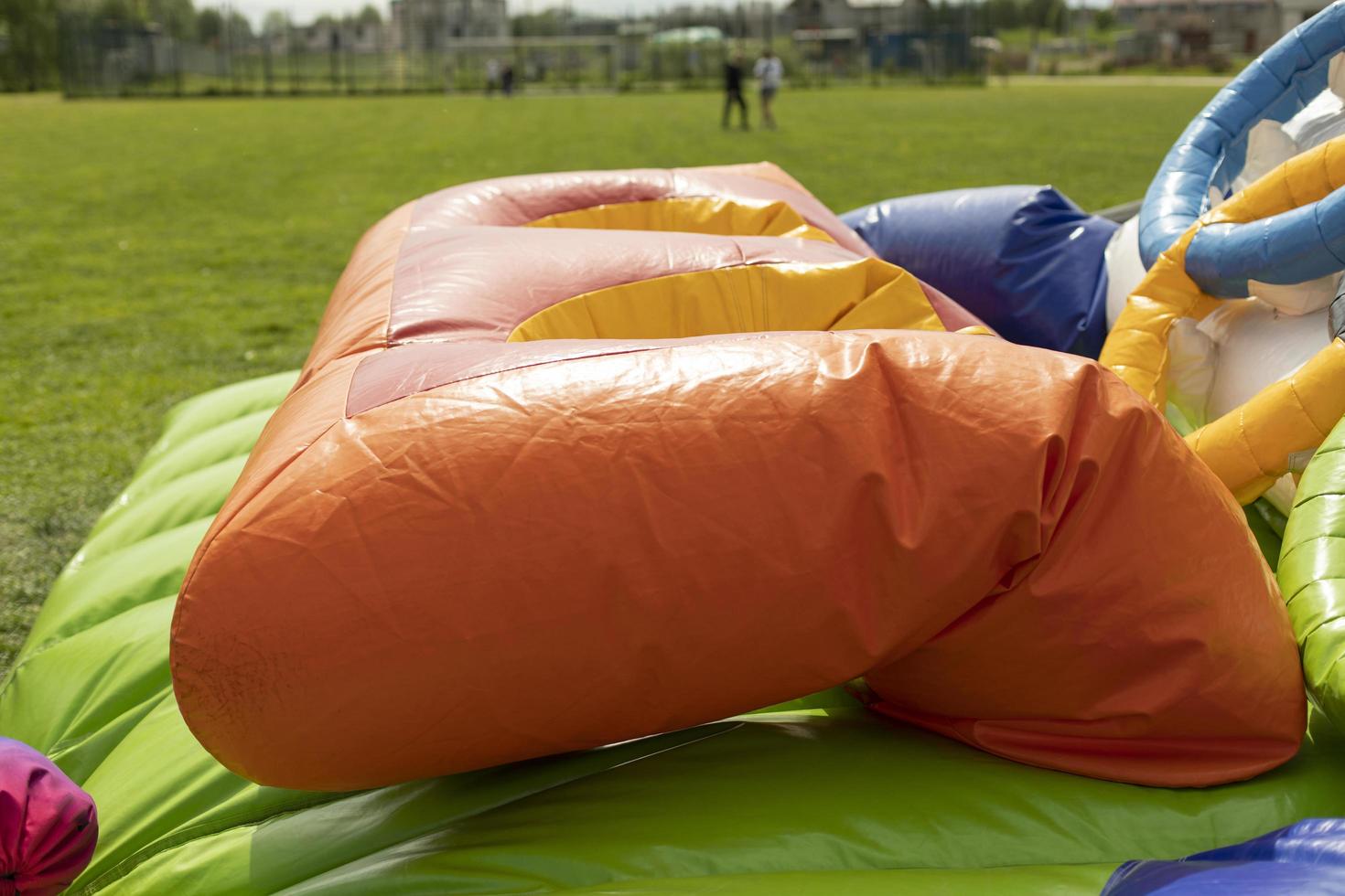 Deflating inflatable trampoline. Amusement park gathering. Details of playground. photo