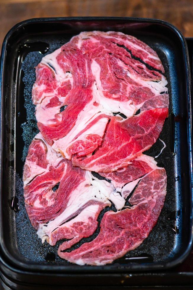 Slide raw beef for Yakiniku. Thin piece beef for Shabu hotpot japanese food style. Close up fresh meat chuck eye for Sukiyaki. top view photo
