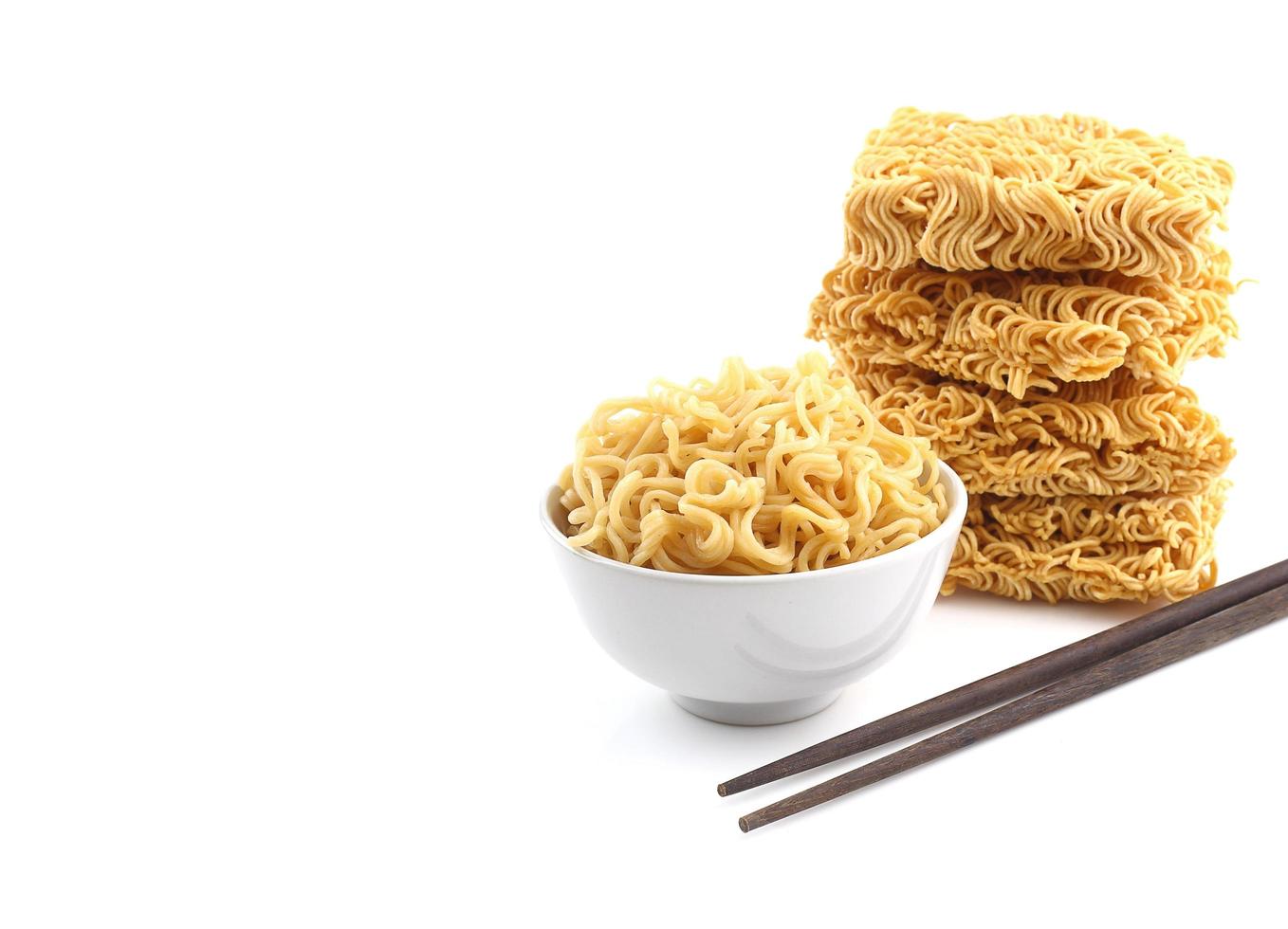 Bowl of noodles  and heap of dry noodle with chopsticks photo