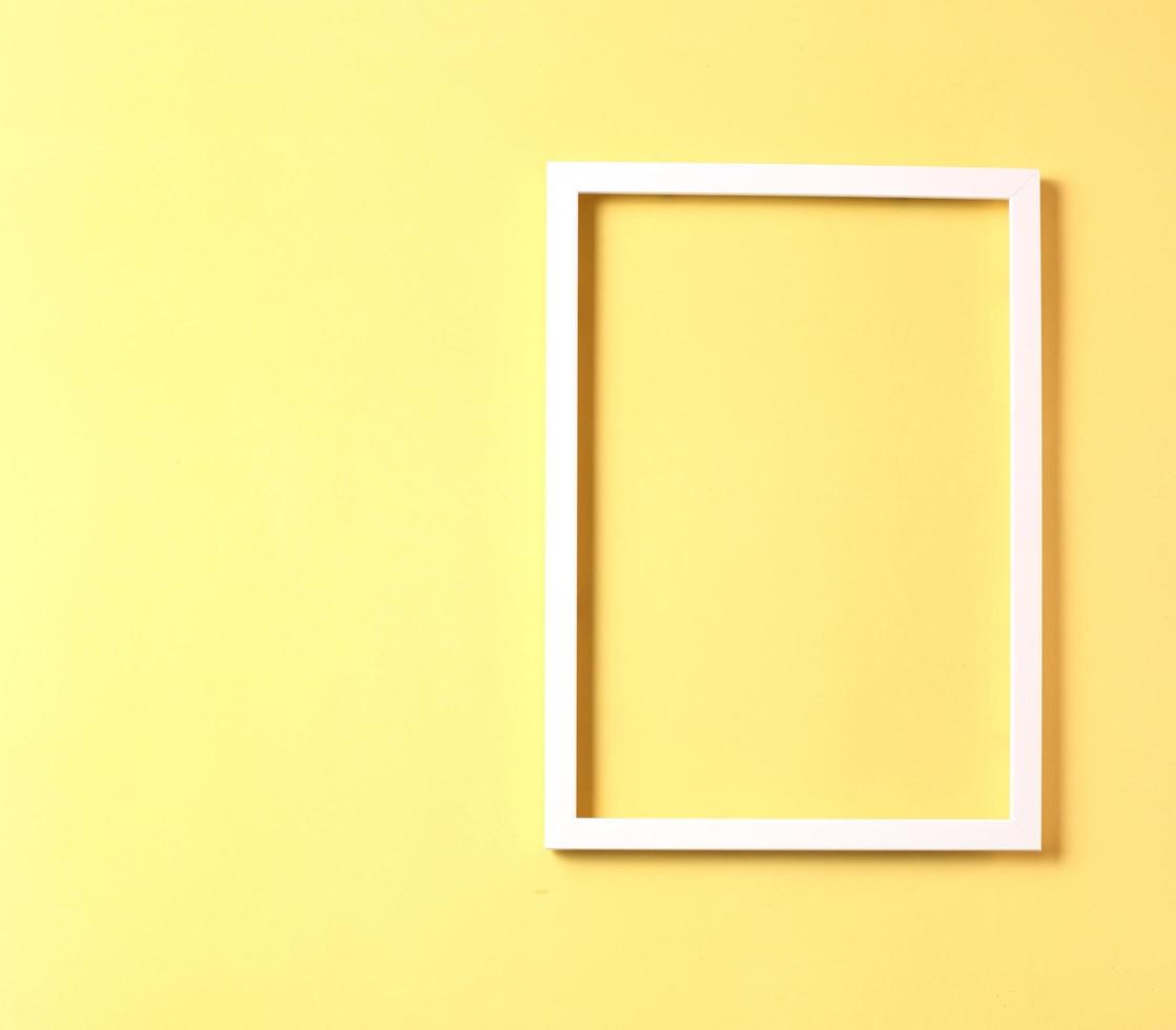 White photo frame on pastel yellow color