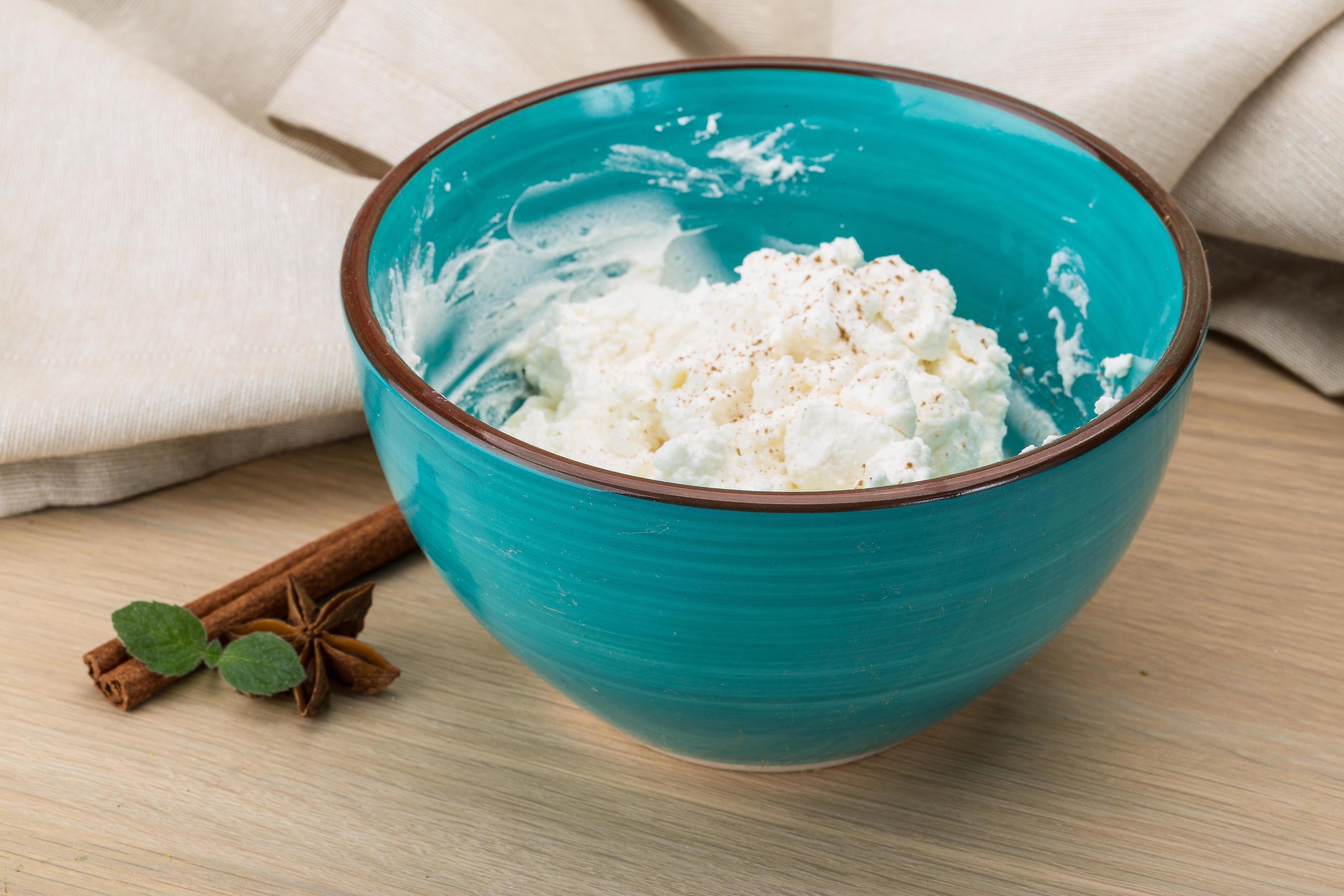 Ricotta cheese in a bowl on wooden background 11735665 Stock Photo at Vecteezy