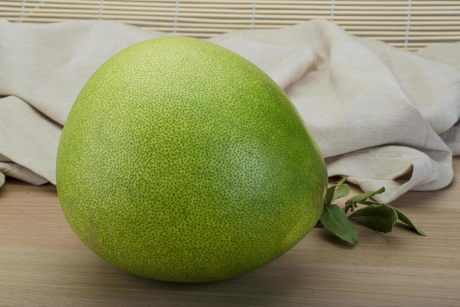Pomelo on wooden background photo