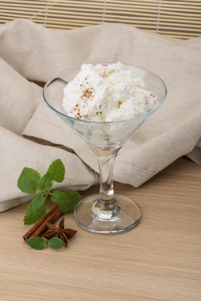 Ricotta cheese on wooden background photo