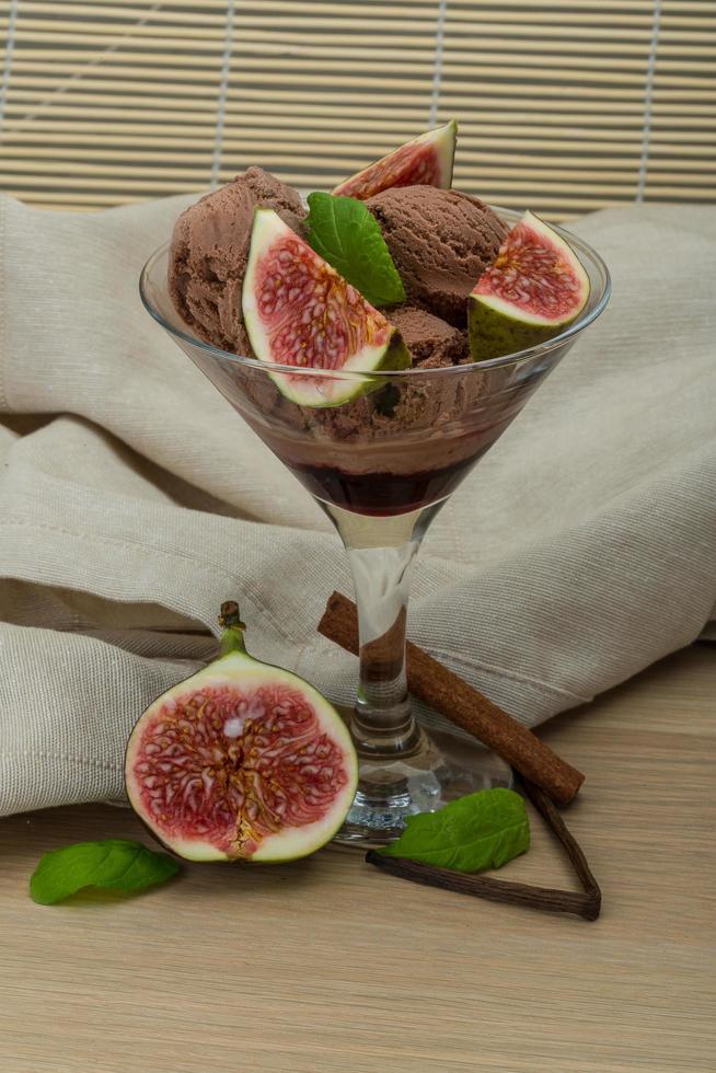 Ice cream with fig on wooden background photo