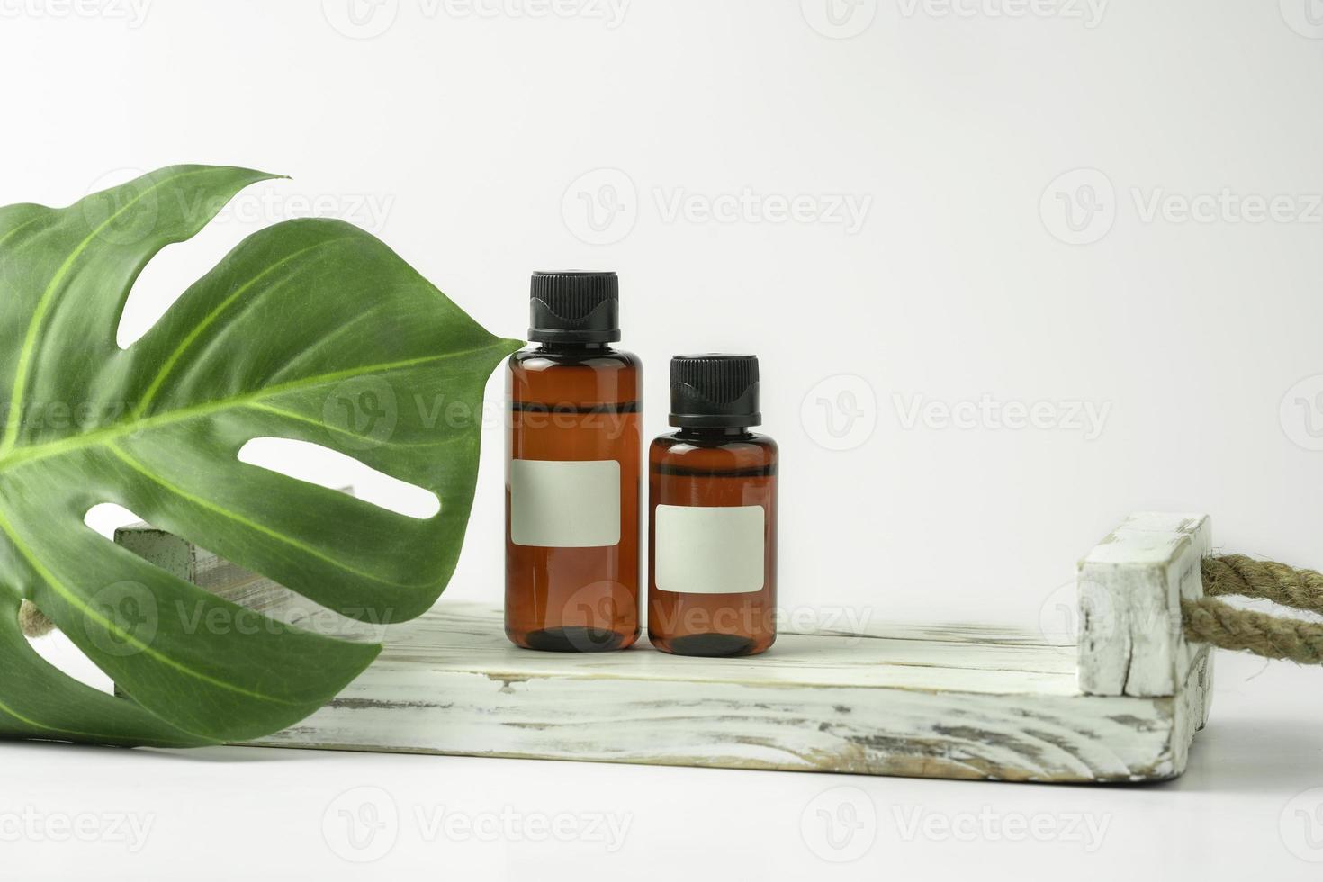 CBD hair natural oil or serum standing on the white wooden tray photo