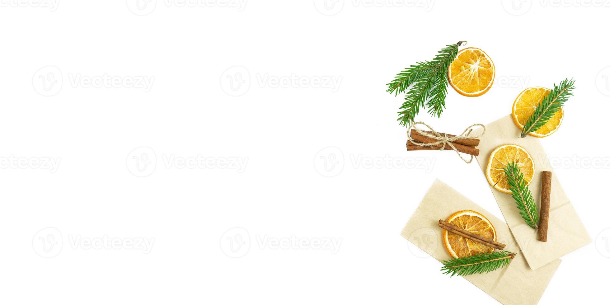 Dried oranges with cinnamon lie on a white background. Copy space photo