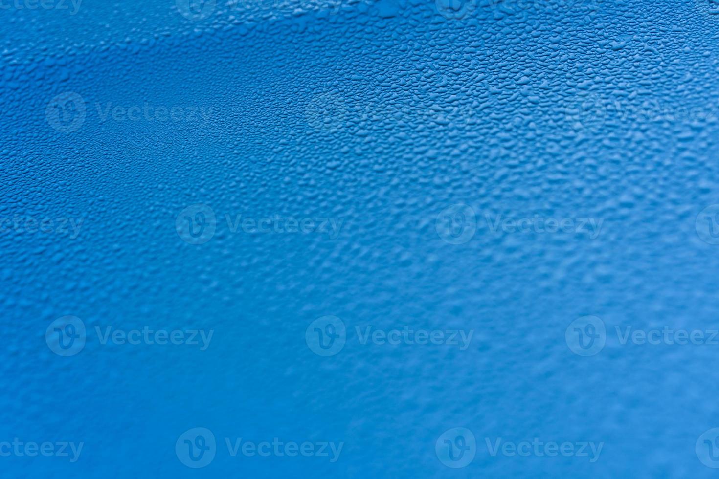 Raindrops on the hood of the car. Close-up. photo