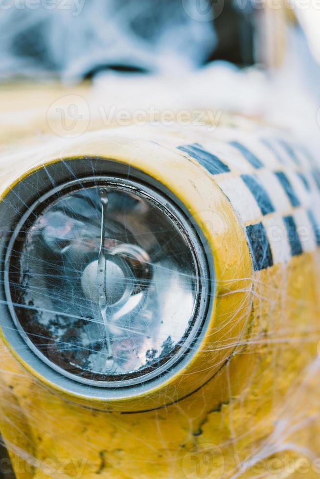 Old retro yellow taxi decorated with cobwebs photo