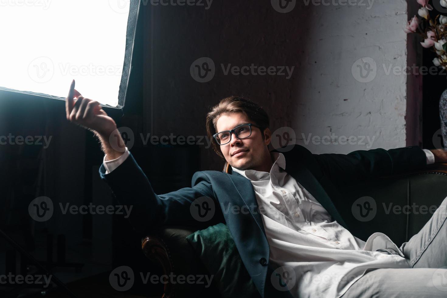 close-up portrait of an attractive young man relaxing on the couch photo