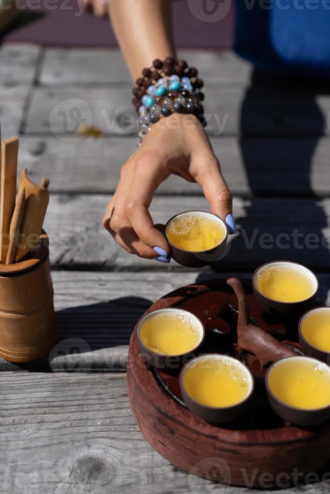 Top view tea set a wooden table for tea ceremony background. Woman and man holding a cup of tea photo