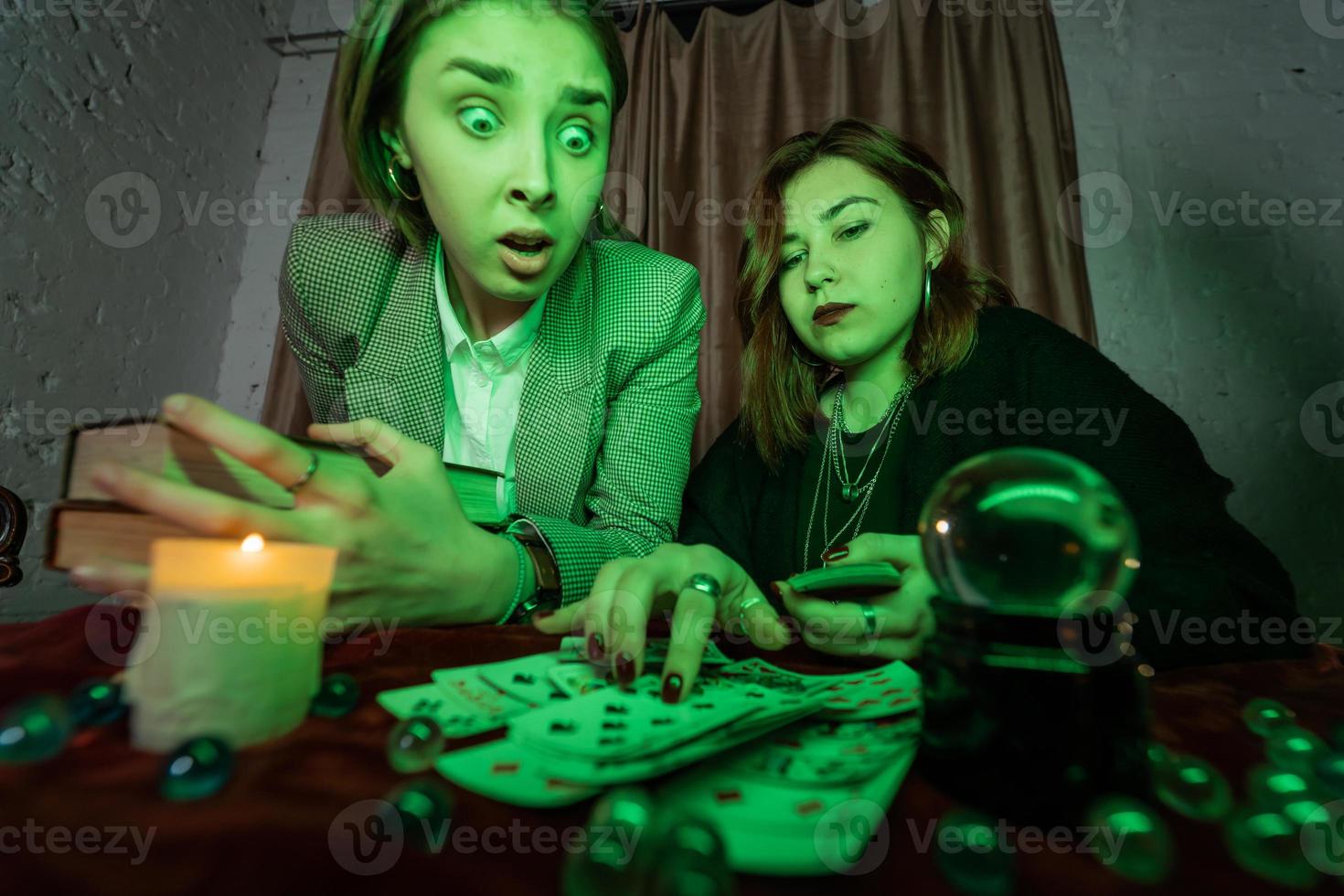 Fortune teller forecasting the future to woman with cards photo