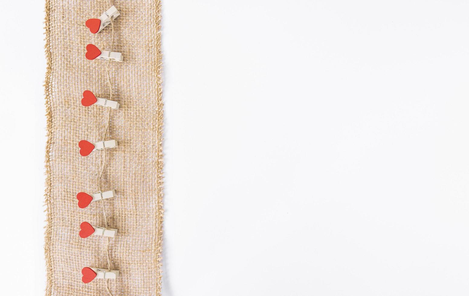 Red hearts hang on a brown string as a decoration for Valentines Day photo