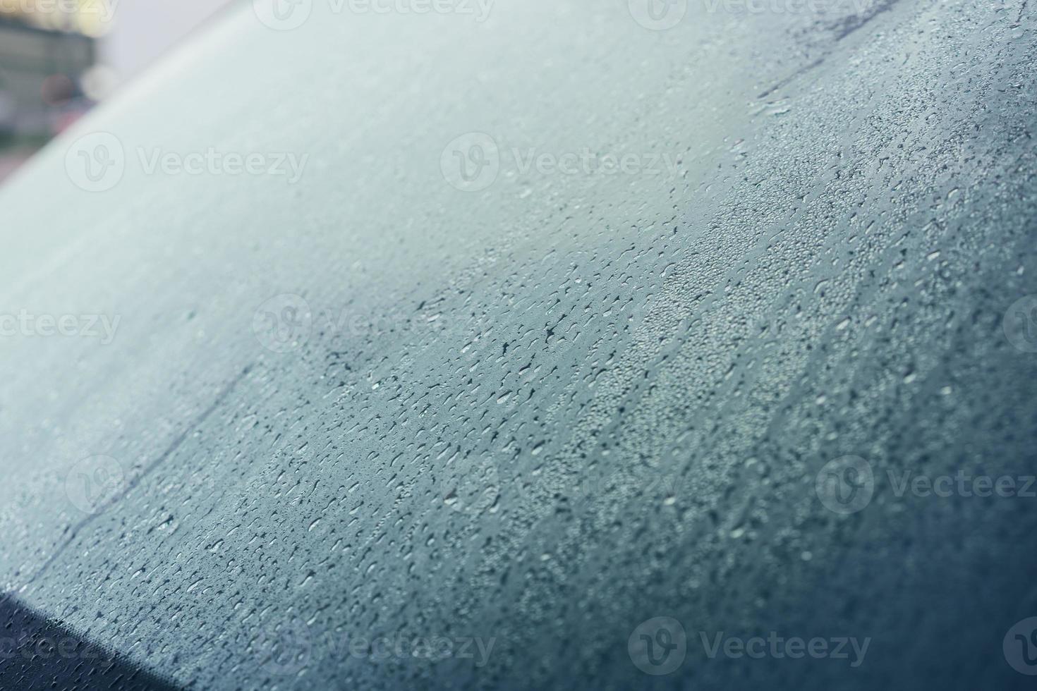 Raindrops on the hood of the car. Close-up. photo