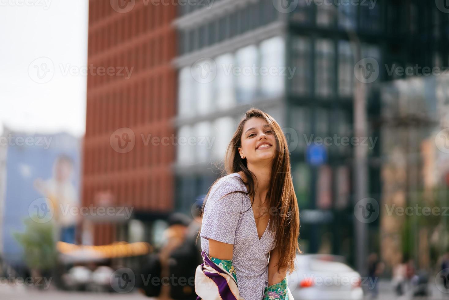 Portrait of pretty young woman, having fun at the street. photo