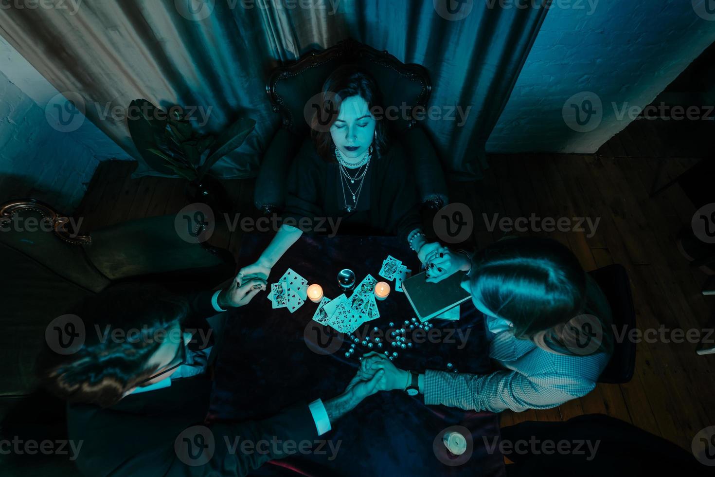 People hold hands of night at table with candles photo