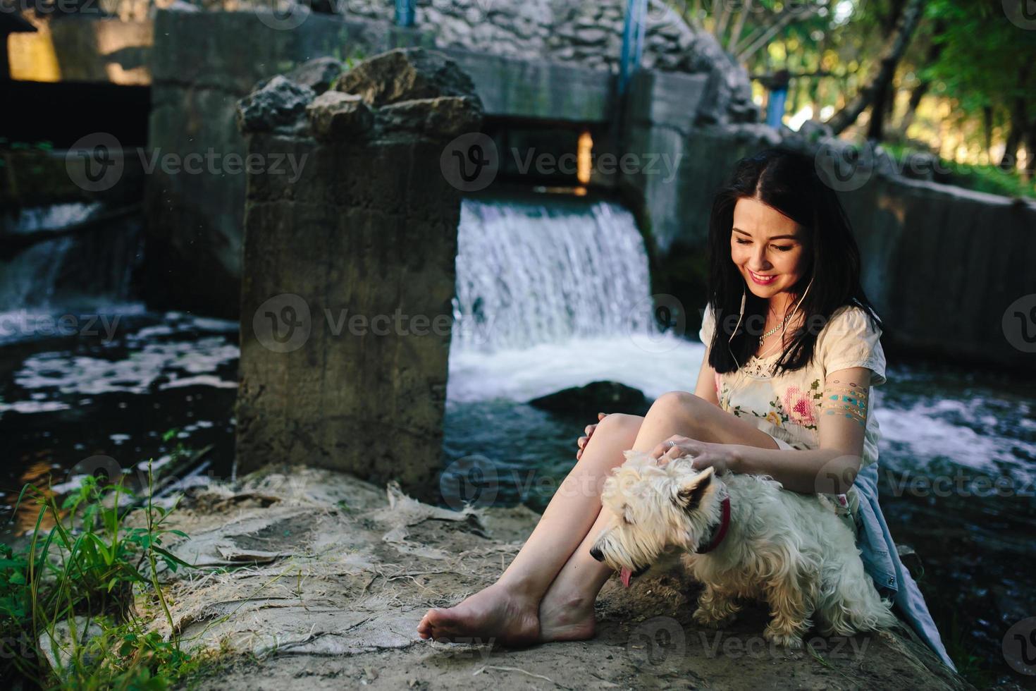 girl playing with a dog photo