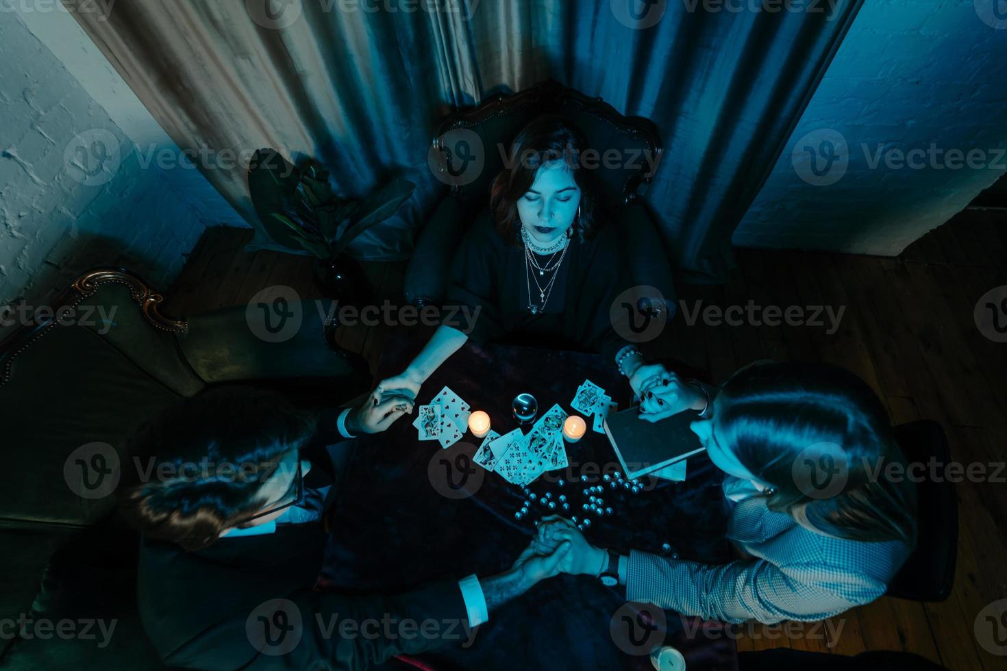People hold hands of night at table with candles photo