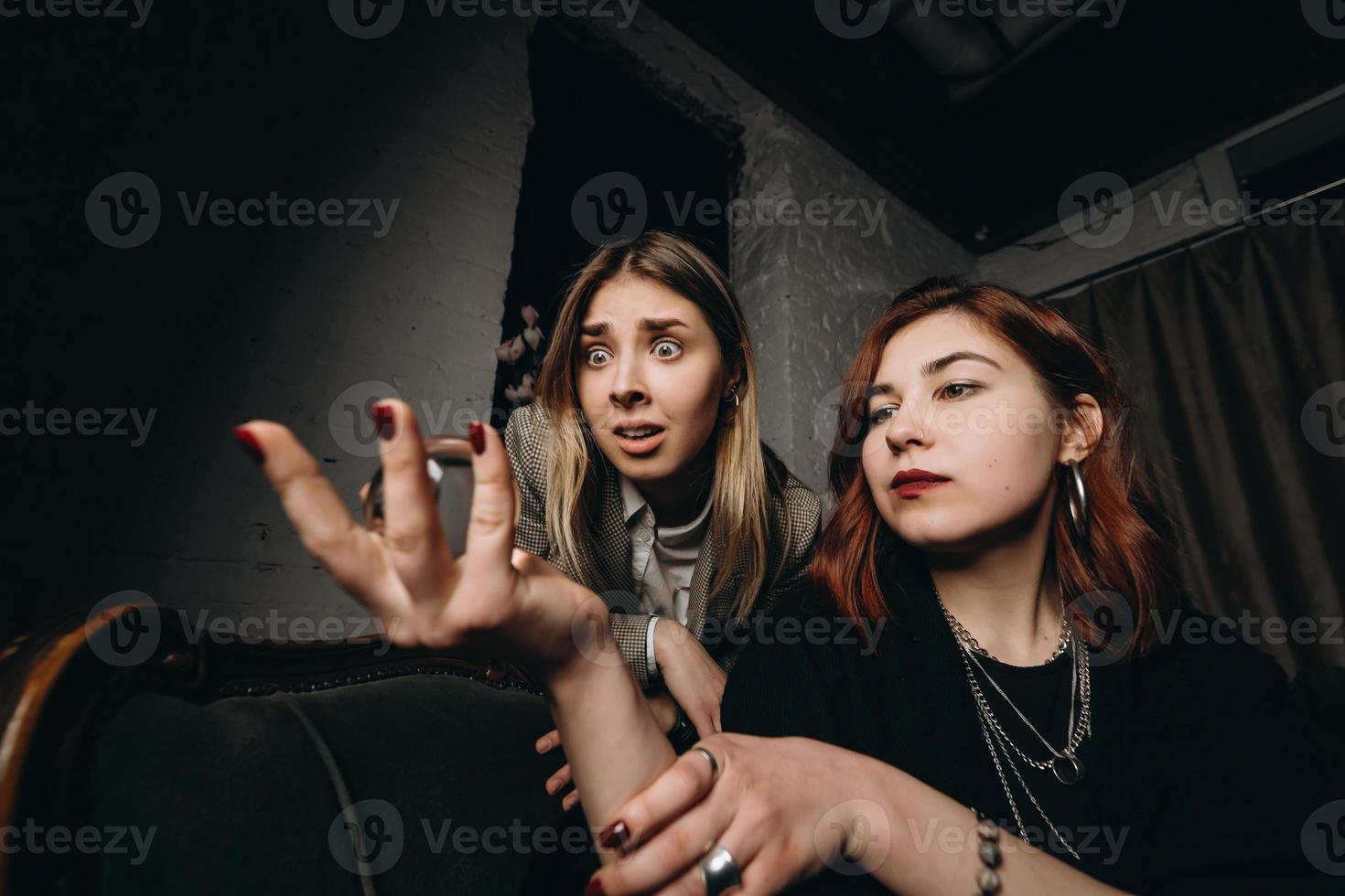 Woman and woman fortune teller with crystal ball photo