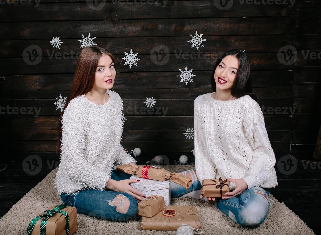 Two pretty girls with gifts for Christmas photo