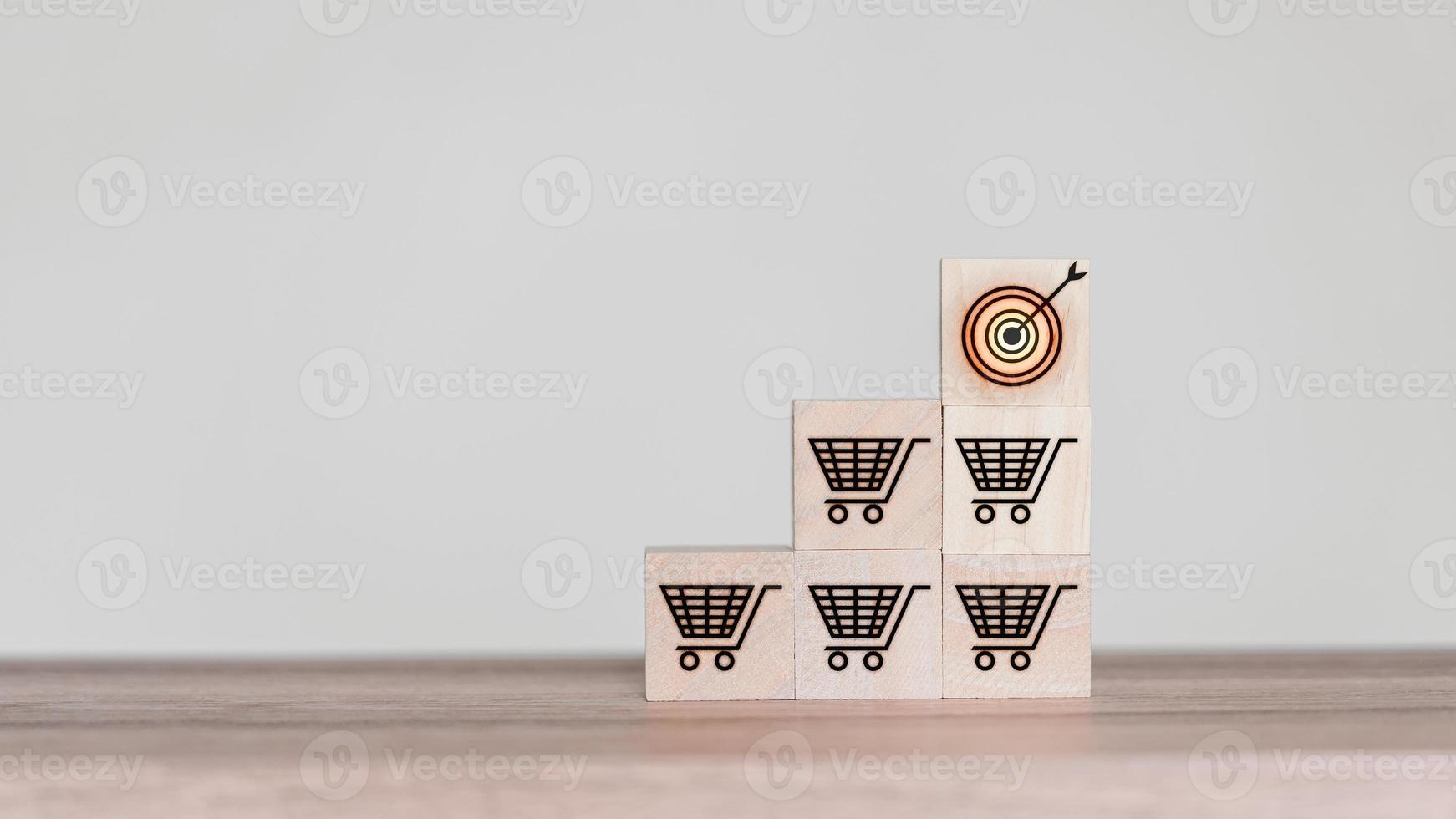 Increasing sales volume to achieve business growth goals, wooden cube blocks with shopping cart symbol. photo