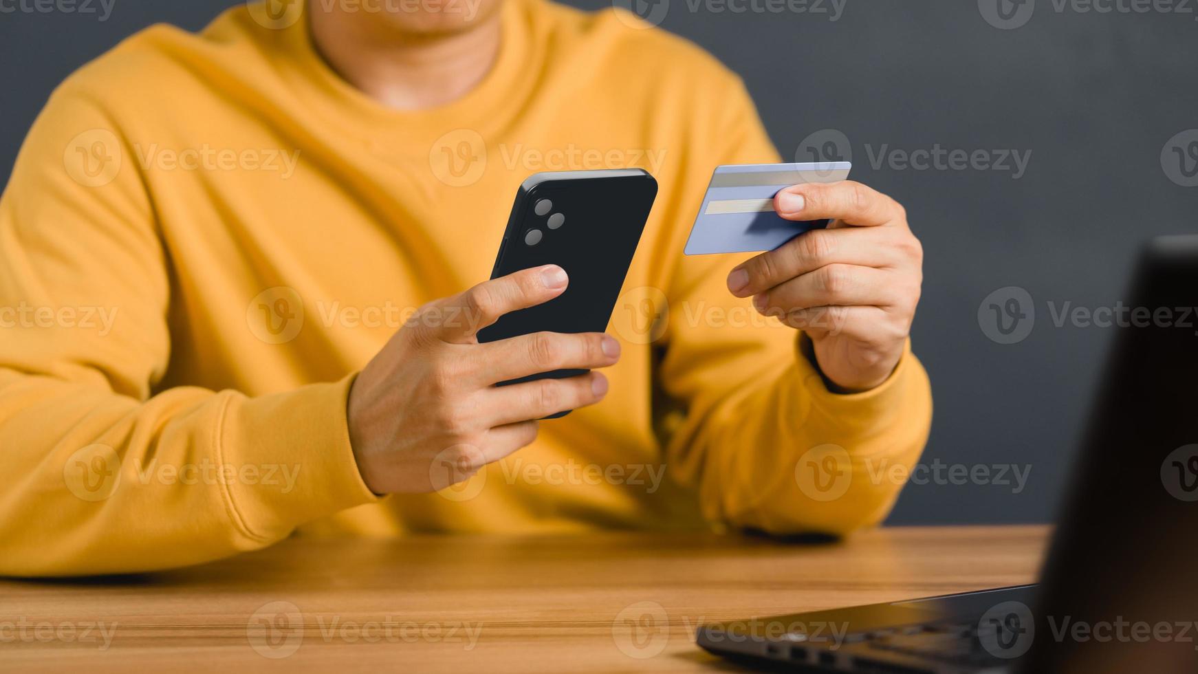 A man using credit card for purchasing and shopping online on mobile phone. Mobile payment with wallet app technology. Digital money transfer, banking and e commerce concept. photo