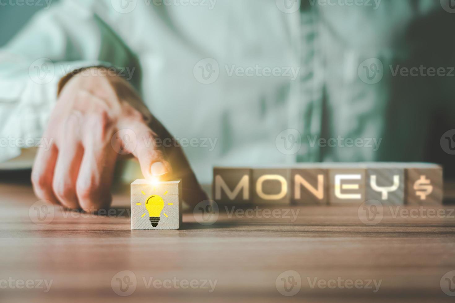 Businessman's hand scrolling the light bulb creative idea icon on wooden cube block forword. Business growth in concept. photo