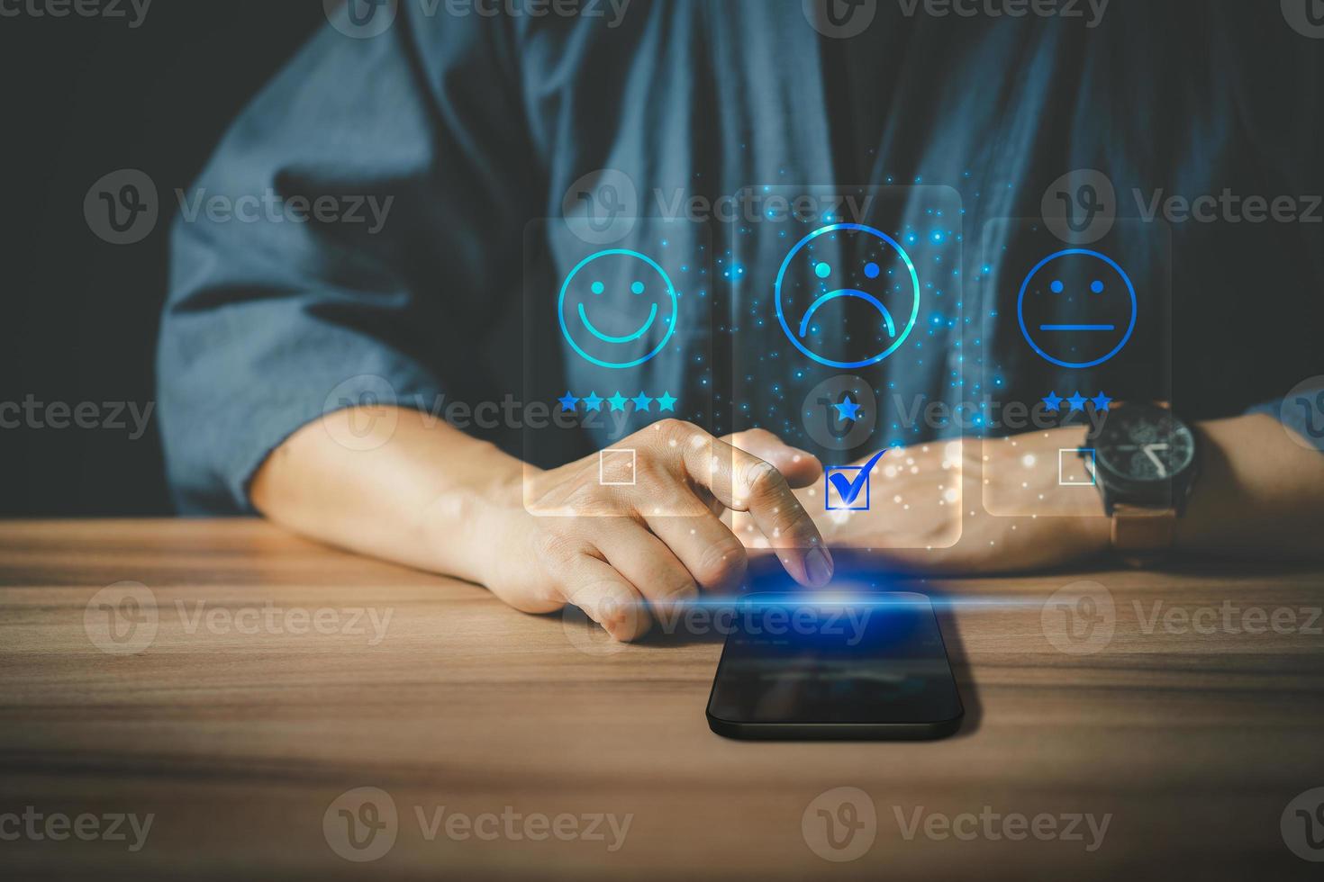 Man using a smartphone in give rating to service experience on application. Online customer review satisfaction feedback survey. photo