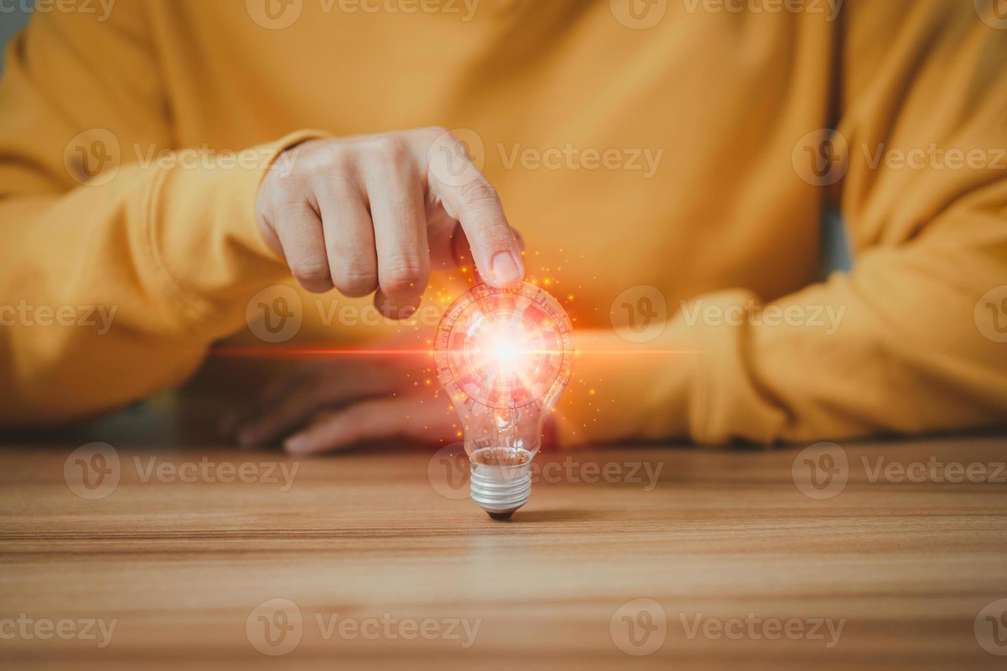 Man touching a bright light bulb. Ideas for presenting new ideas, inspiration in the work and innovation new beginning. photo